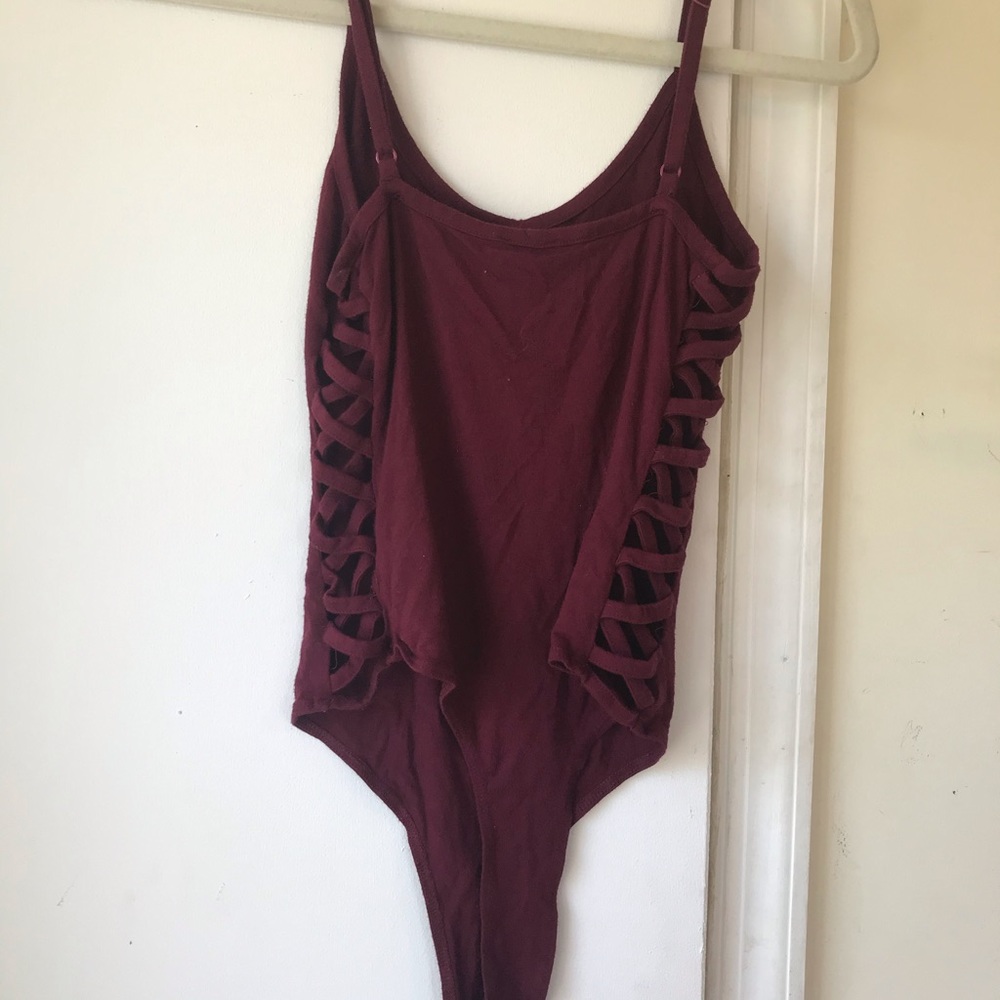 Maroon bodysuit with crisscross detailing on side